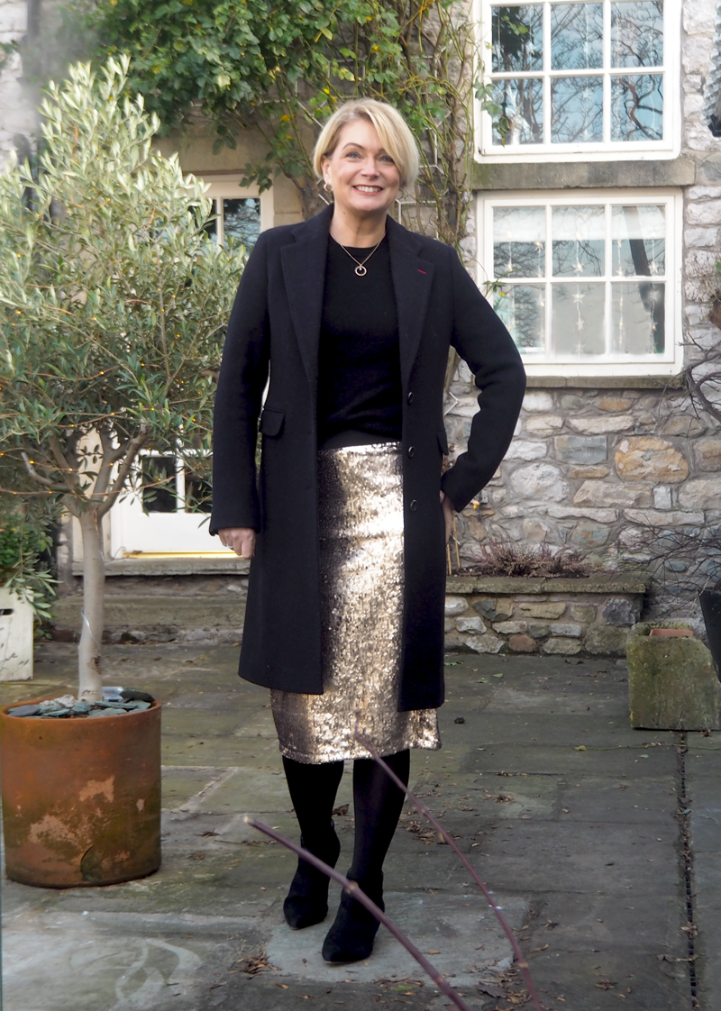 Black crombie coat, gold sequin skirt