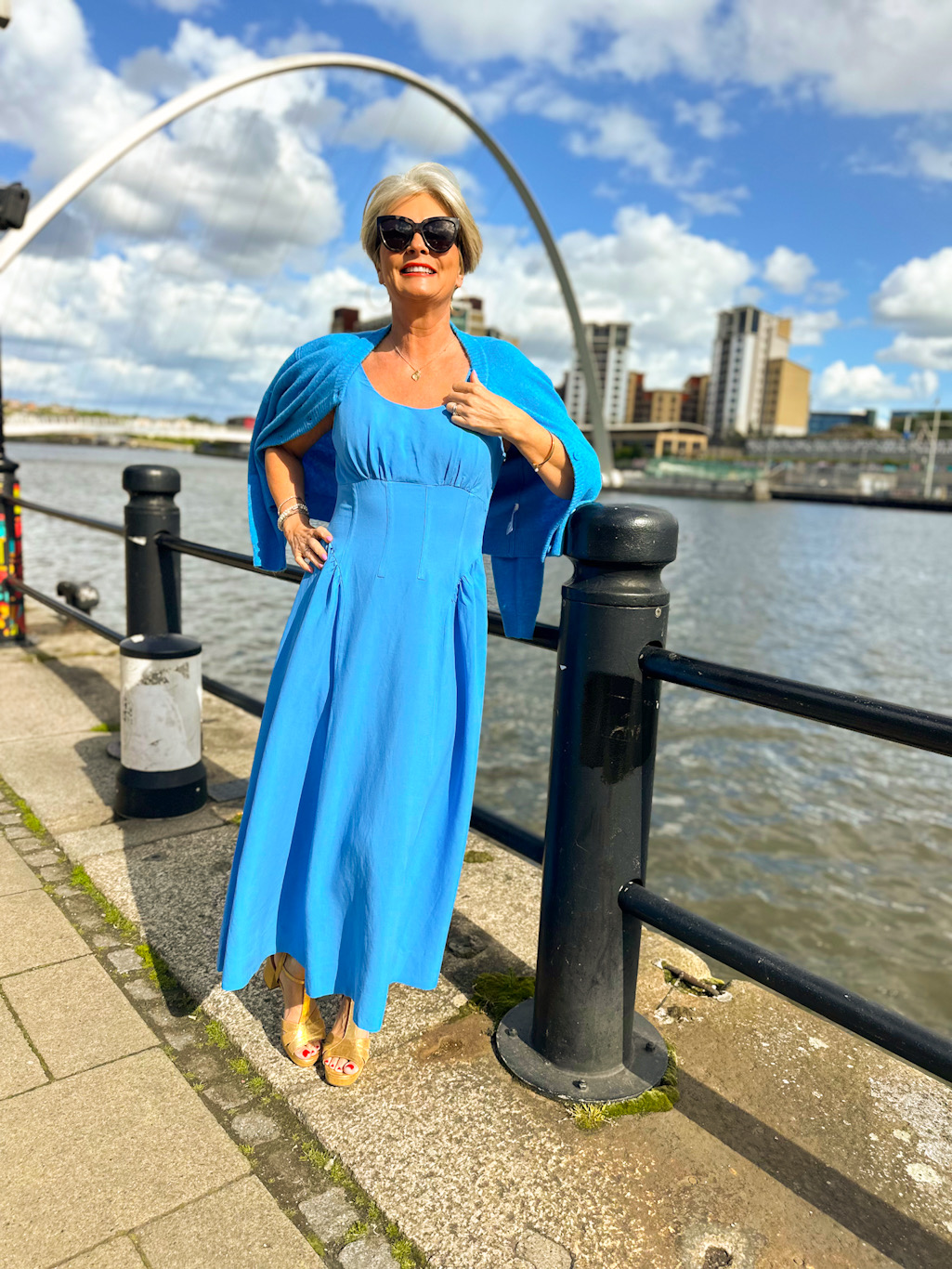 Nikki Garnett shoulder-robing the matching blue cardigan over the John Lewis panelled dress for a midlife summer look