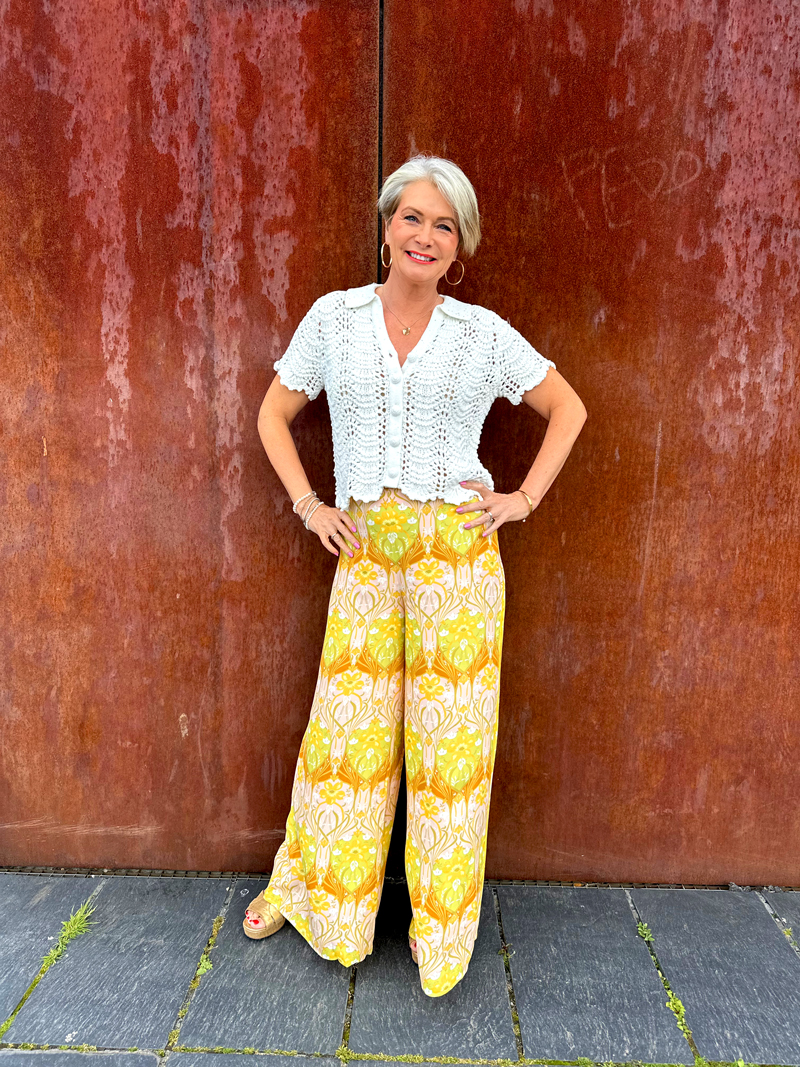Nikki Garnett wearing Florere paisley palazzo trousers with a sequin-detail crochet top, a midlife dressed-up summer look