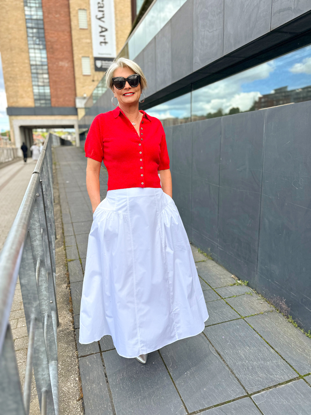 Nikki Garnett wearing the Topshop ribbed red polo top with John Lewis white panelled cotton skirt